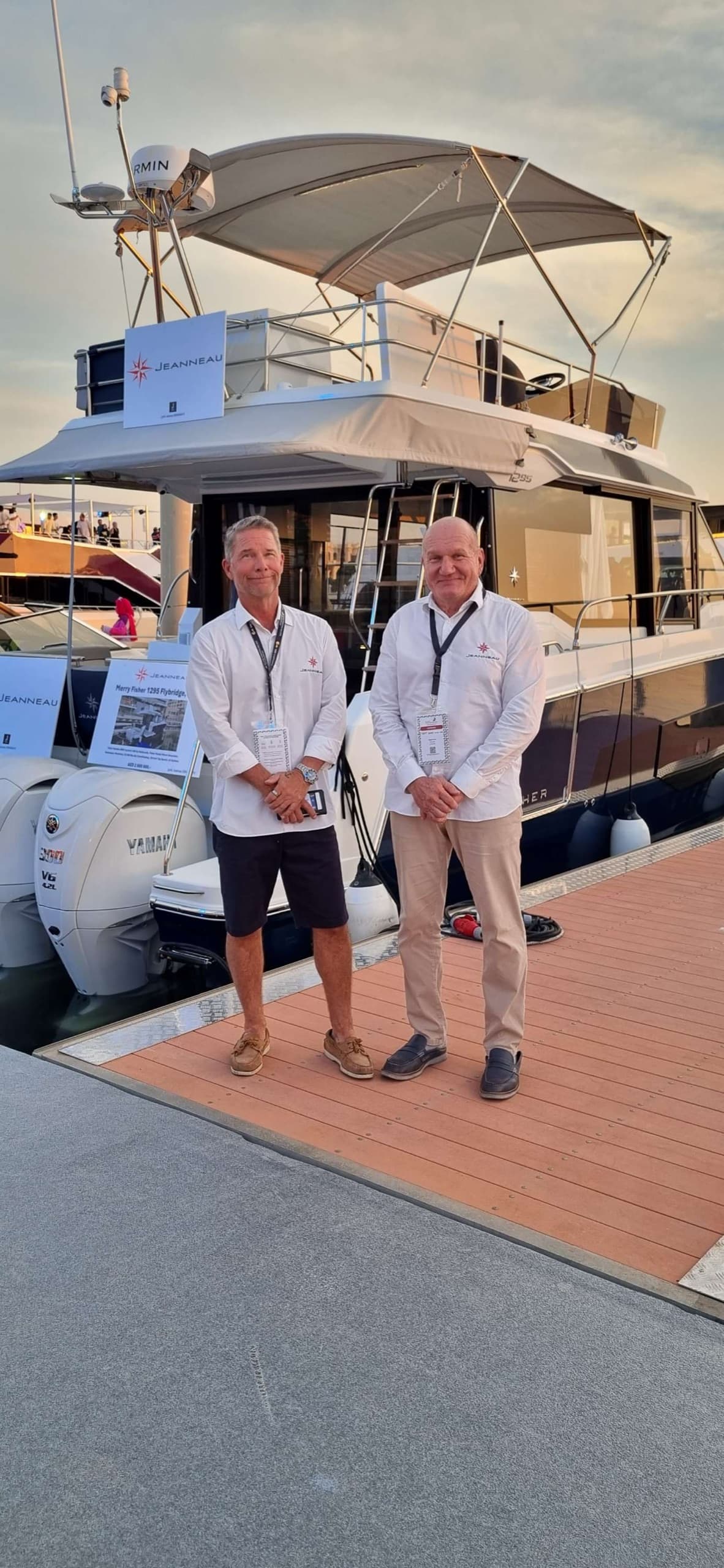 The JJ Marine team on the dock beside a Jeanneau